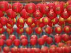 Lanterns hang above the street in China Town in London in honor of the Chinese Lunar New Year. by the Forward
			