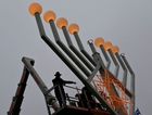 Rabbis inspecting a giant public menorah in Berlin. by the Forward
			