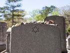A Jewish headstone with rocks set on it. by the Forward
			