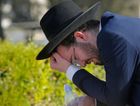 An man mourns at Segula cemetery during the funeral of a victim of the stampede at a Lag B'Omer event at Mount Meron in Israel. by the Forward
			
