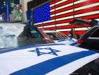 An American flag is reflected off car windows decorated in Israeli flags during a car parade marking Israel’s 73rd Yom Ha’Atzmaut (Independence Day) amid the coronavirus pandemic in Times Square on April 18, 2021 in New York City. by the Forward
			