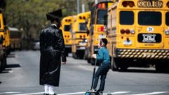 Young yeshiva student with his father in Brooklyn, New York by the Forward
			