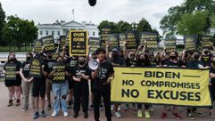 Members of the Sunrise Movement hold signs during a protest near the White House in Washington, D.C., U.S., on Friday, June 4, 2021. President Biden has pitched to Republicans the idea of a 15% minimum tax on U.S. corporations, along with strengthened IRS enforcement efforts, as a way to fund a bipartisan infrastructure package. Photographer: Shuran Huang/Bloomberg via Getty Images by the Forward
			