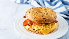 A bacon bagel sandwich by the Forward
			