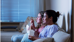 Two women eat Chinese food while watching a movie by the Forward
			