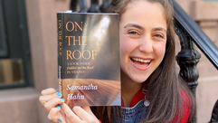 Samantha Hahn poses with her book "On The Roof: A Look Inside _Fiddler on the Roof_ in Yiddish." by the Forward
			