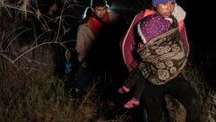 Asylum-seeking migrants approach a U.S. Border Patrol checkpoint. by the Forward
			