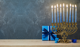 A menorah and gifts by the Forward
			