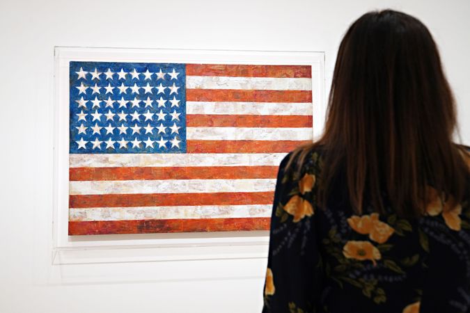 Jasper Johns' painting of the American flag is seen on display during a press preview of MoMA’s first ever Fall Reveal at Museum of Modern Art on November 13, 2020 in New York City. by the Forward 