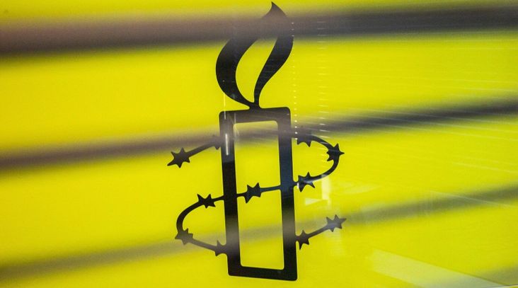 The Amnesty International logo is seen in their office in Hong Kong, October 2021. (Isaac Lawrence/AFP via Getty Images)