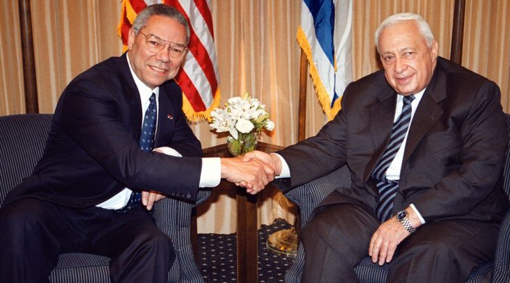 US Secretary of State Colin Powell, left, shakes hands with Israeli Prime Minister-elect Ariel Sharon in Jerusalem on February 25, 2001. (Getty Images/Pool photo)