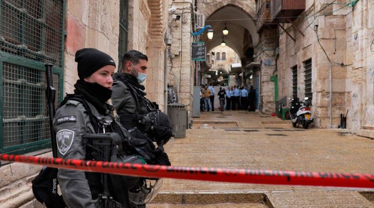 Israeli border guards stand guard behind a security perimeter at the scene of a shooting in the old city of Jerusalem, Nov. 21, 2021.(Menahem Kahana/AFP via Getty Images)