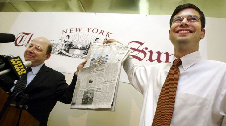Seth Lipsky, left, then editor and publisher of The New York Sun, holds up a copy of the first issue with Ira Stoll, vice president and managing editor, during a news conference Apr. 16, 2002 in New York City. The paper is being relaunched online after its purchase by Dovid Efune, the former CEO and editor in chief of the New York-based Algemeiner Journal. (Mario Tama/Getty Images)