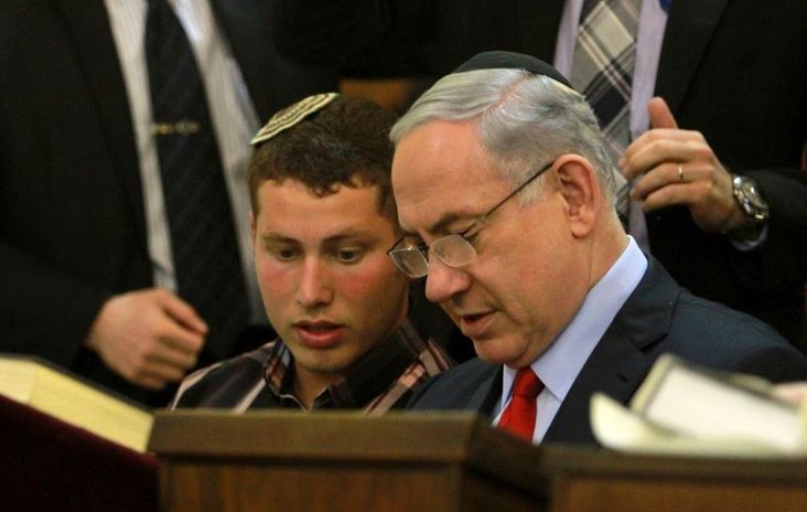 Israeli Prime Minister Benjamin Netanyahu and his son Avner read the book of Esther at Jerusalem's Great Synagogue on March 5, 2015 during the holiday of Purim.