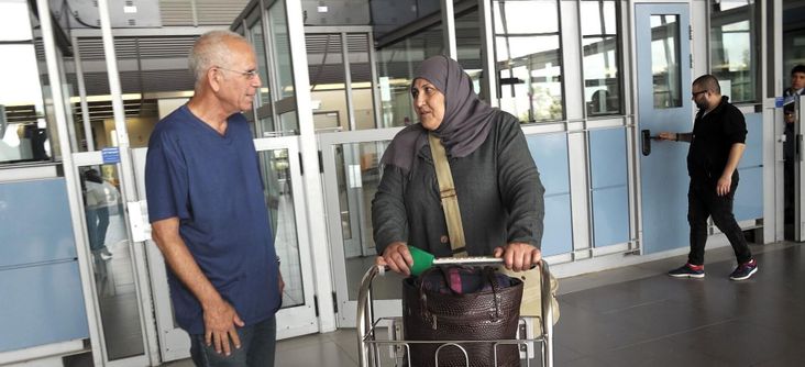 Yuval Roth, founder of Road to Recovery, greets Siham, a cancer patient from Gaza, at the Erez checkpoint.