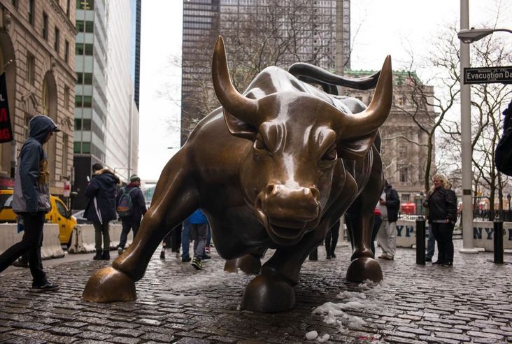 The brass Charging Bull sculpture stands near the Financial District April 2, 2018 in New York City.