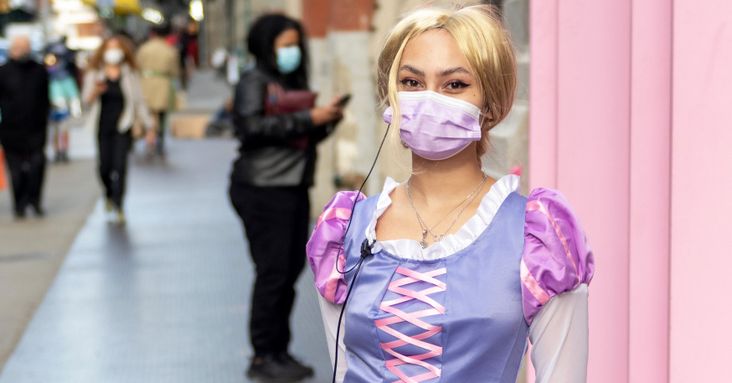 A woman dressed as Rapunzel from Disney's 'Tangled' movie wearing a mask due to the coronavirus pandemic.