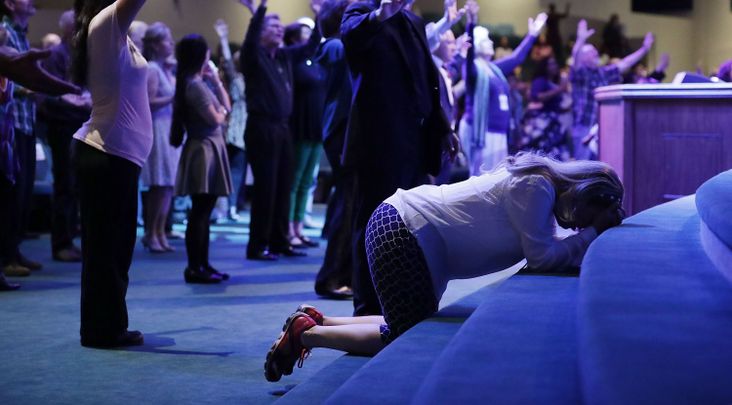 Worshippers pray during a service at the International Church of Las Vegas