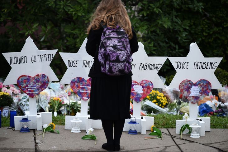 Woman standing at a memorial outside the Tree of Life Synagogue