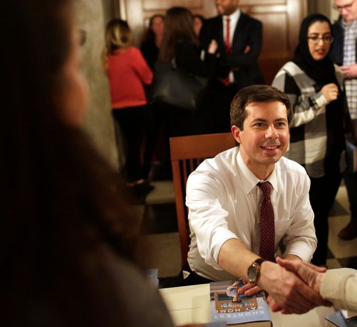 South Bend, Indiana Mayor Pete Buttigieg greets a guest as he signs copies of his book 'Shortest Way Home'