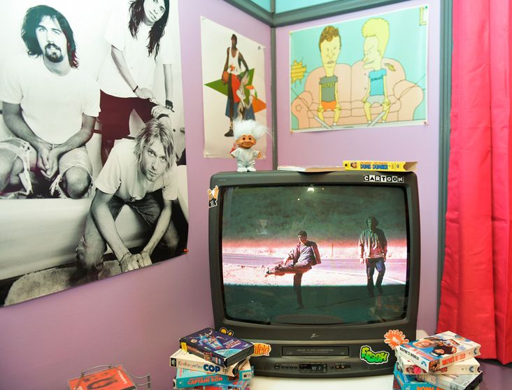 A "Beavis and Butt-Head" poster in a model '90s bedroom.