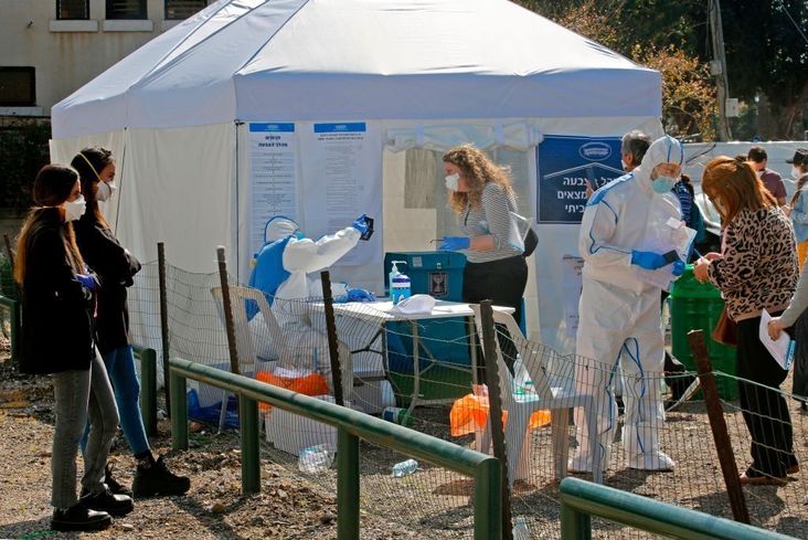 Israelis wearing protective masks vote at one of the special polling station erected for the 5,600 voters under quarantine, many of whom had visited countries where the coronavirus COVID-19 is prevalent, during parliamentary election on March 2, 2020 in Tel Aviv.