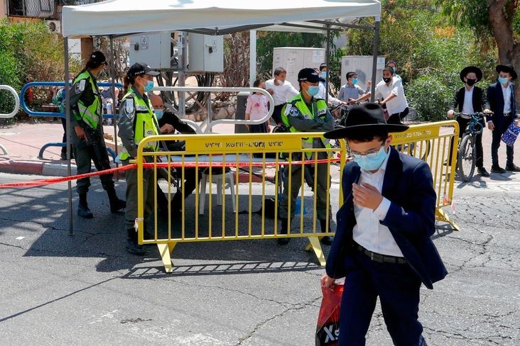 Israeli security forces, wearing protective masks due to the COVID-19 pandemic, control access to a neighbourhood that has been isolated following a recent increase in coronavirus cases in the southern coastal city of Ashdod, on July 2, 2020.