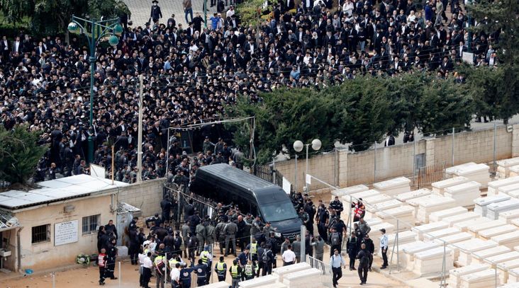 Jewish mourners wait outside Ponevezh community cemetery in the city of Bnei Brak near Tel Aviv in central Israel during the funeral of haredi Rabbi Chaim Kanievsky, March 20, 2022. (Jack Guez/AFP via Getty Images)