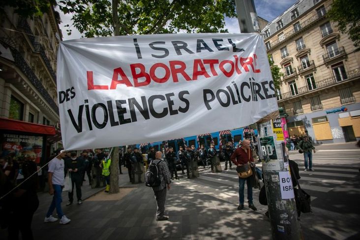 A banner reading 'Israel, police violence laboratory' is displayed during a rally as part of the 'Black Lives Matter' worldwide protests against racism and police brutality on Place de la Republique on June 13, 2020 in Paris, France.