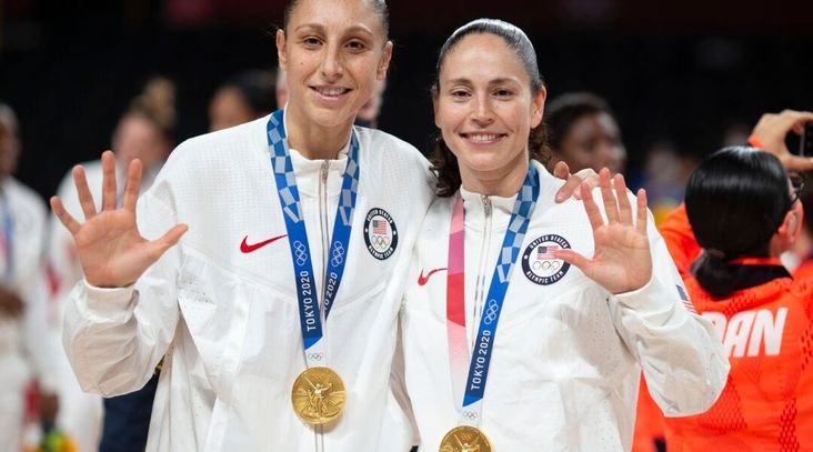 Five-time Olympic gold medalists Diana Taurasi, (left) and Sue Bird of the United States with their gold medals after the team victory against Japan in the basketball final during the Tokyo Olympics.