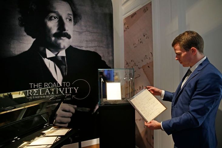 Vincent Belloy, a specialist in the Books and Manuscript department at Christie's, poses with the Einstein manuscript.
