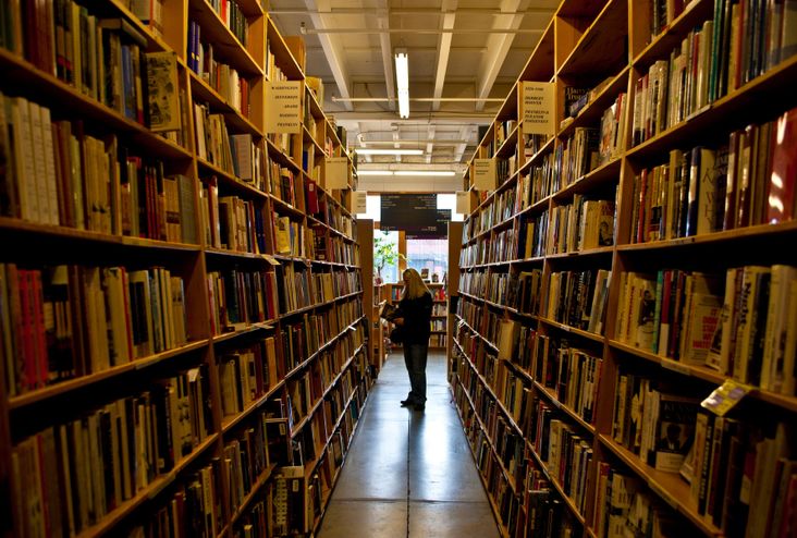 A customer browses the shelves at Powell's.