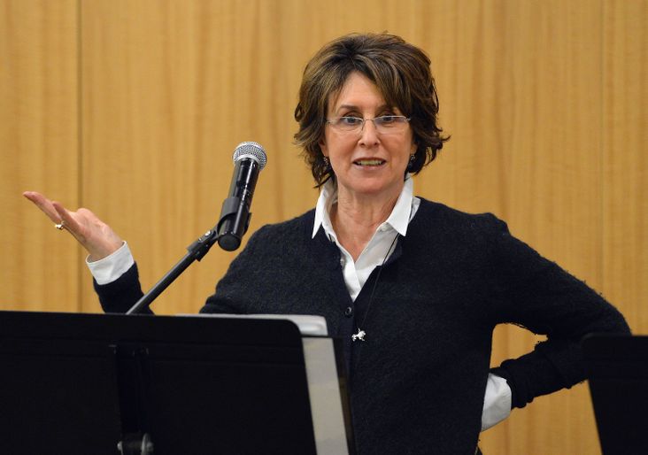 Delia Ephron lectures at a podium