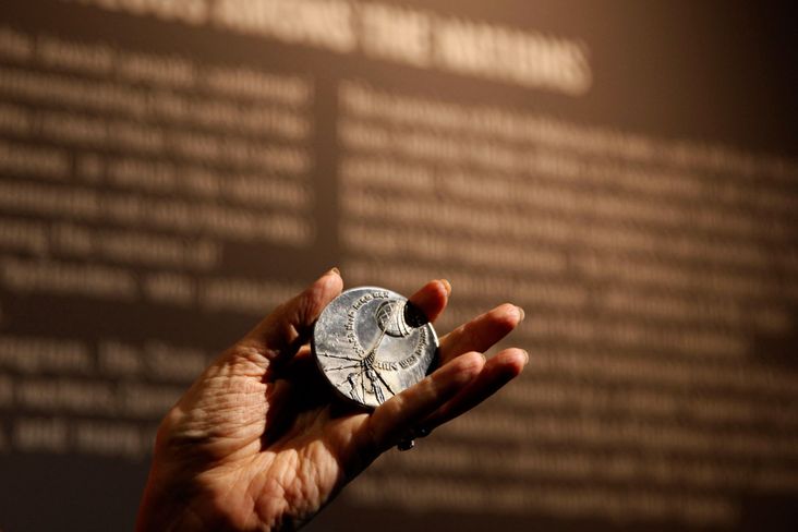 Irena Steinfeldt the director of the Righteous Among the Nations department at the Yad Vashem Holocaust memorial Museum, holds the "Righteous Among The Nations," medal, which is given to non-Jews who stood up to the Nazi genocide during the war, that was awarded to late Egyptian Dr Mohammed Helmy on September 30, 2013 in Jerusalem.