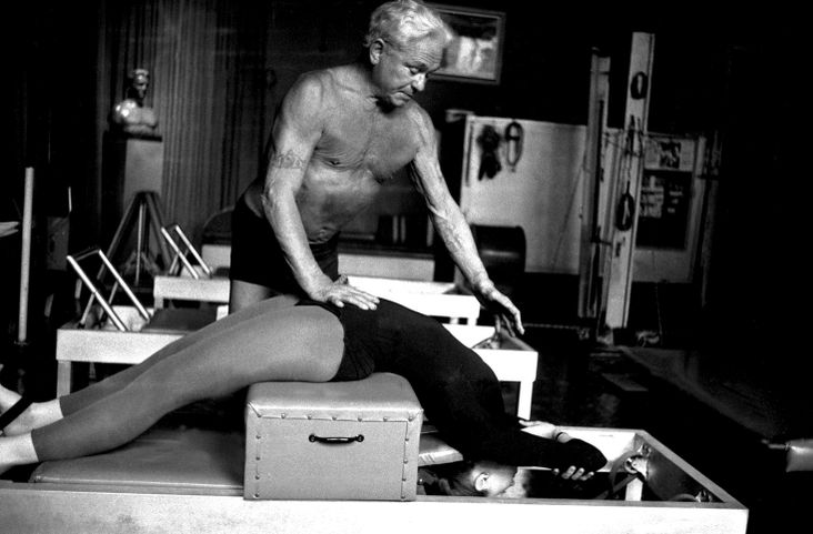 Joseph Pilates in his New York studio with a client.