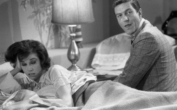 Dick Van Dyke sits beside his wife played by Mary Tyler Moore on 'The Dick Van Dyke Show.'