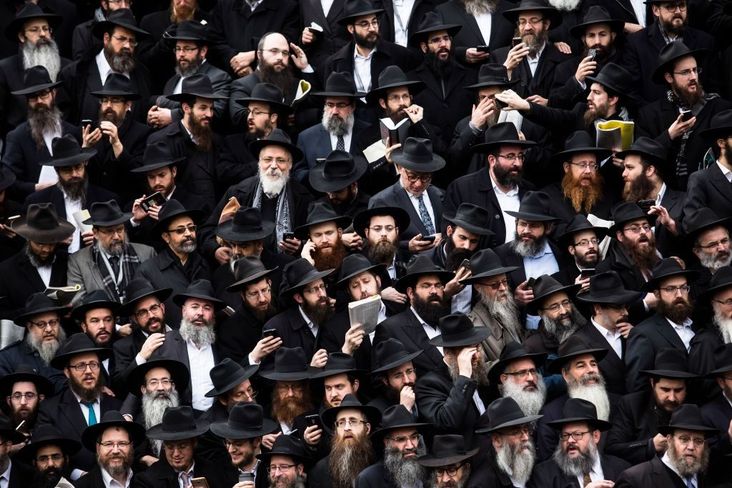 Hasidic rabbis prepare to pose a group photo, part of the annual International Conference of Chabad-Lubavitch Emissaries, in front of Chabad Lubavitch World Headquarters.