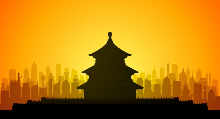 A Pagoda against a yellow-orange sky and what is theoretically Shanghai