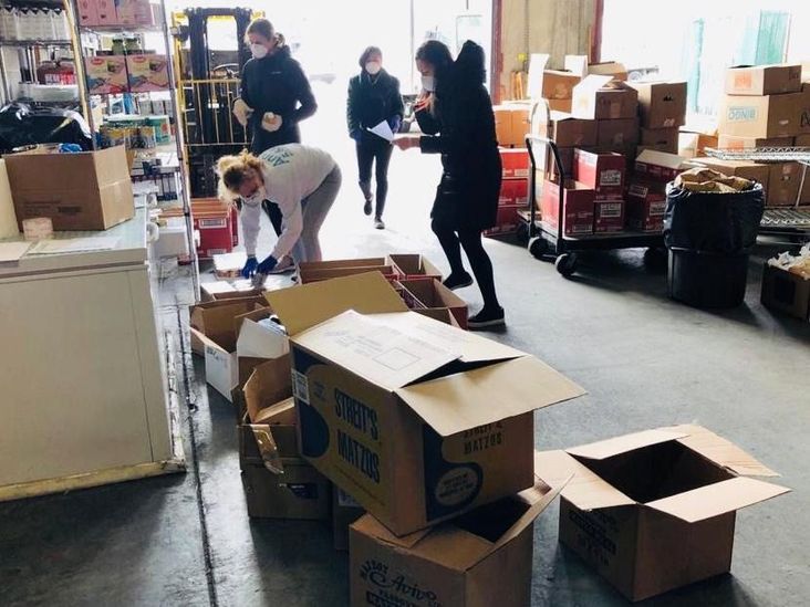 Volunteers packing boxes of Passover food.