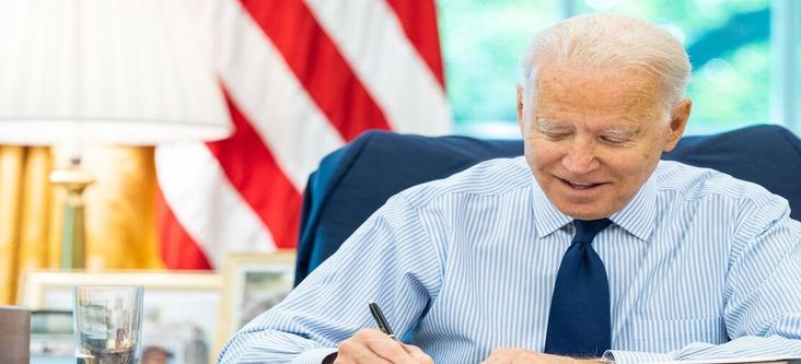 President Joe Biden talks on the phone with U.S. Senator Tom Carper, D-Del., during congressional call time on Friday, July 16, 2021, in the Oval Office