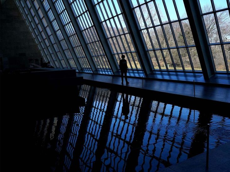 A person walks past the windows at The Metropolitan Museum of Art in New York on March 15, 2021, near the Temple of Dendur in The Sackler Wing