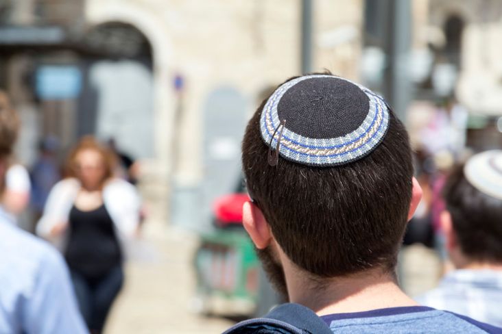 A man wearing a yarmulke on the streets of Jerusalem.
