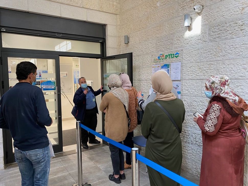 Patients waiting for vaccinations at a health clinic in the East Jerusalem neighborhood of Beit Hanina.